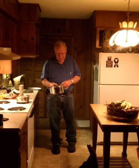 Buck helps to prepare a late evening cabin meal